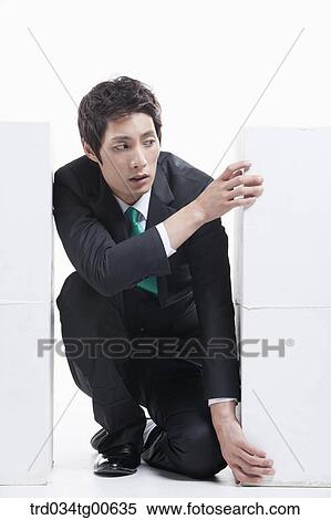 A man stuck between the piled boxes View Large Photo Image Stock Photography - A man stuck between the piled boxes. Fotosearch