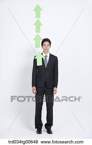 A man with rising green arrows View Large Photo Image Stock Photo - A man with rising green arrows . Fotosearch