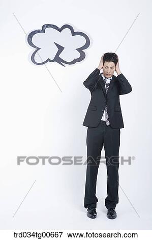 Stock Photo - A stressful man having hands on the head with dark lightening cloud. Fotosearch