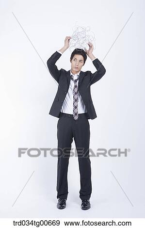 A stressful man holding up twisted wire ball View Large Photo Image Stock Photo - A stressful man holding up twisted wire ball. Fotosearch