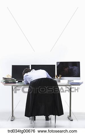 A stressful man in front of monitors View Large Photo Image Stock Photograph - A stressful man in front of monitors . Fotosearch