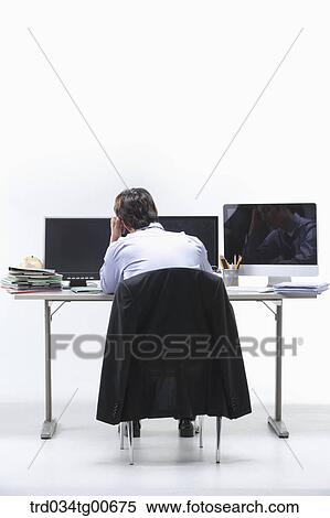 A stressful man in front of monitors View Large Photo Image Stock Photography - A stressful man in front of monitors . Fotosearch