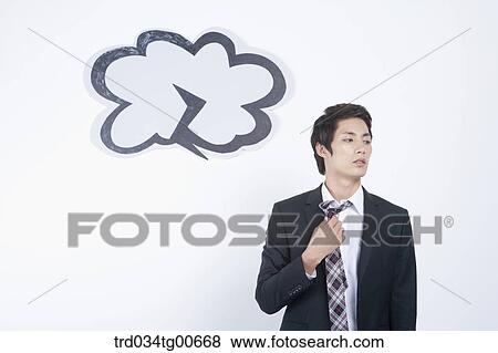 Stock Photo - A stressful man taking out his tie with dark lightening cloud. Fotosearch