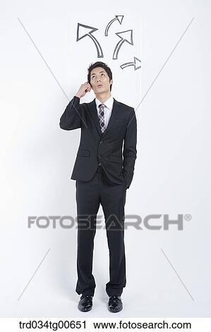 A thinking man having a finger on his head with rising arrows View Large Photo Image Stock Image - A thinking man having a finger on his head with rising arrows. Fotosearch