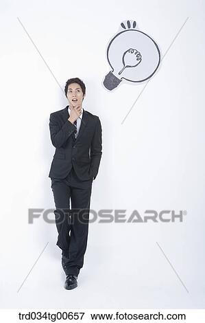 A thinking man having his hand on the chin with the bulb View Large Photo Image Stock Photo - A thinking man having his hand on the chin with the bulb. Fotosearch