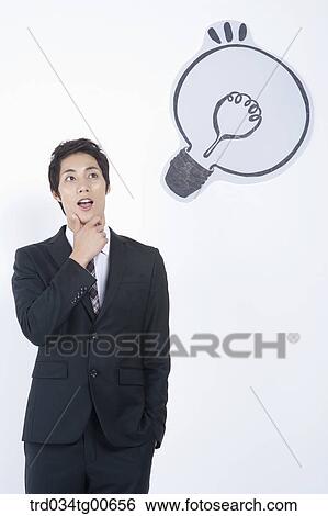 A thinking man having his hand on the chin with the bulb View Large Photo Image Stock Photograph - A thinking man having his hand on the chin with the bulb. Fotosearch