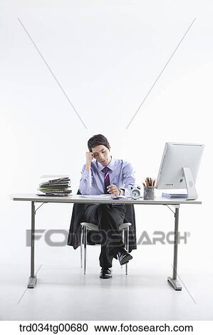 A thinking man while sitting on his desk View Large Photo Image Stock Image - A thinking man while sitting on his desk. Fotosearch