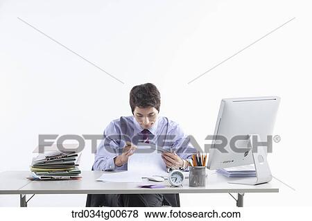A thinking man while sitting on his desk View Large Photo Image Stock Photo - A thinking man while sitting on his desk. Fotosearch