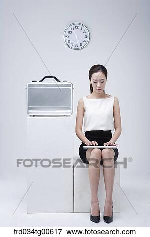 Stock Photo - A typing woman with clock and suitcase. Fotosearch