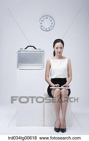 A typing woman with clock and suitcase View Large Photo Image Stock Photo - A typing woman with clock and suitcase. Fotosearch