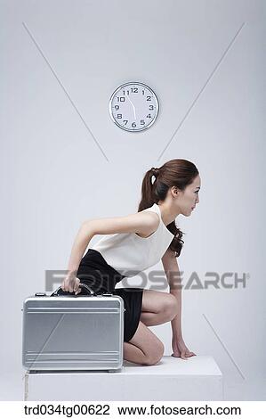 A woman about to run holding suitcase with clock background View Large Photo Image Stock Image - A woman about to run holding suitcase with clock background. Fotosearch