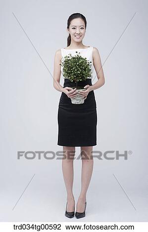 A woman holding green pot View Large Photo Image Stock Image - A woman holding green pot . Fotosearch