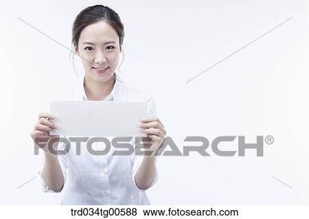 Stock Photo - A woman holding white paper. Fotosearch