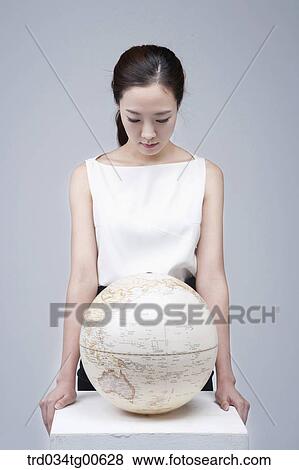A woman looking down on the globe View Large Photo Image Stock Photo - A woman looking down on the globe. Fotosearch