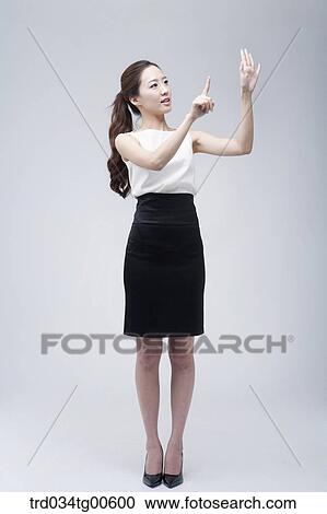 Stock Image - A woman pointing her hand. Fotosearch