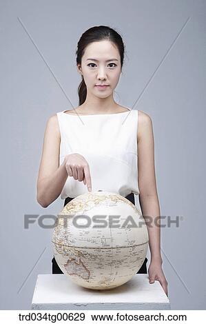 A woman pointing the globe View Large Photo Image Stock Photo - A woman pointing the globe . Fotosearch