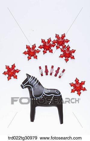 The black wooden horse, red party clips and red snowflake View Large Photo Image Stock Photo - The black wooden horse, red party clips and red snowflake. Fotosearch