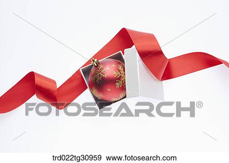 The red and gold Christmas ball in the white box with red decoration tie View Large Photo Image Stock Photo - The red and gold Christmas ball in the white box with red decoration tie. Fotosearch
