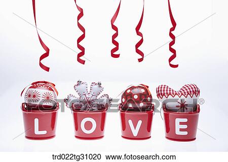 Stock Image - The red, white Christmas patchworks and ball in red love basket with red tie. Fotosearch