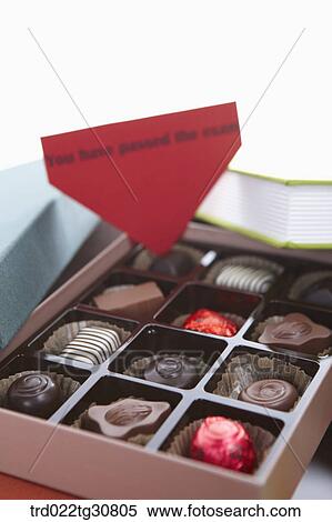 A box of chocolate in the middle of books View Large Photo Image Stock Photography - A box of chocolate in the middle of books. Fotosearch