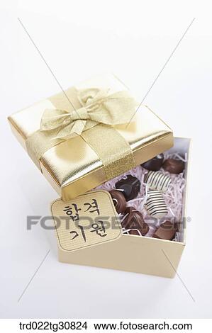 A box of chocolates and a good luck message View Large Photo Image Picture - A box of chocolates and a good luck message. Fotosearch