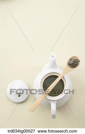 A tea pot of green tea and spoon of tea leaves View Large Photo Image Stock Photo - A tea pot of green tea and spoon of tea leaves. Fotosearch