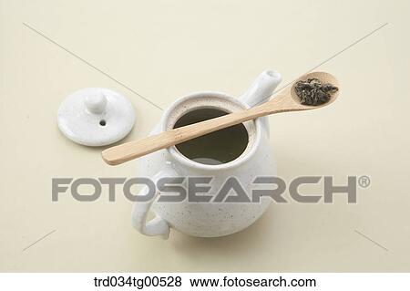 A tea pot of green tea and spoon of tea leaves View Large Photo Image Stock Photo - A tea pot of green tea and spoon of tea leaves. Fotosearch