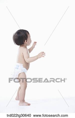 Baby boy in nappy standing View Large Photo Image Stock Image - Baby boy in nappy standing. Fotosearch