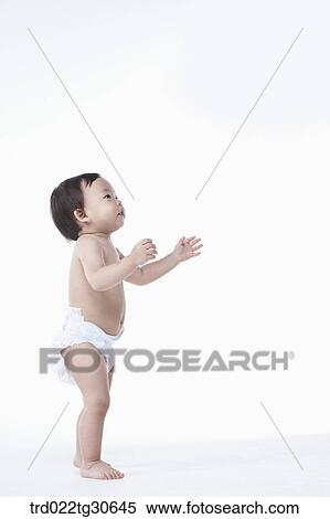 Baby boy in nappy standing View Large Photo Image Stock Photography - Baby boy in nappy standing. Fotosearch
