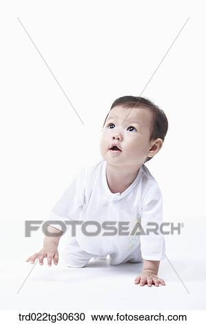 Stock Image - Baby boy in white clothes. Fotosearch