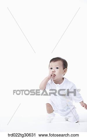 Stock Image - Baby boy in white clothes. Fotosearch