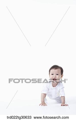 Stock Image - Baby boy in white clothes. Fotosearch