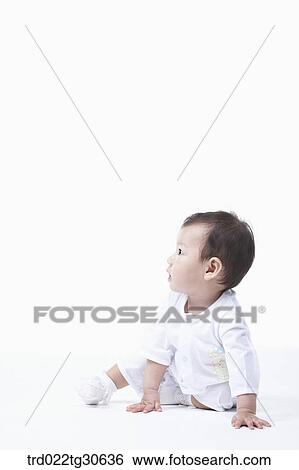 Stock Photograph - Baby boy in white clothes. Fotosearch