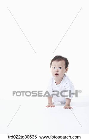 Stock Photography - Baby boy in white clothes. Fotosearch