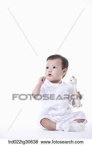 Baby boy in white clothes with a toy giraffe View Large Photo Image Stock Photo - Baby boy in white clothes with a toy giraffe. Fotosearch