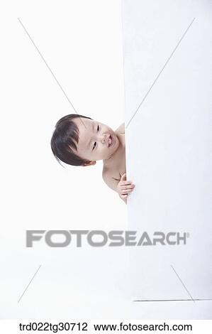 Baby boy peeking from behind a white wall View Large Photo Image Stock Image - Baby boy peeking from behind a white wall. Fotosearch