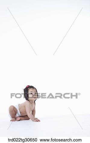 Stock Image - Baby girl in nappy. Fotosearch