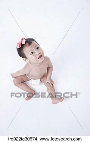 Baby girl in nappy with pink ribbon View Large Photo Image Picture - Baby girl in nappy with pink ribbon. Fotosearch