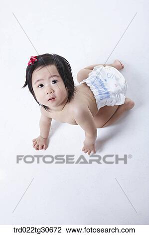 Baby girl in nappy with red ribbon View Large Photo Image Stock Image - Baby girl in nappy with red ribbon. Fotosearch