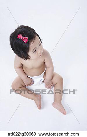 Baby girl in nappy with red ribbon View Large Photo Image Stock Photo - Baby girl in nappy with red ribbon. Fotosearch
