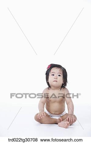 Baby girl in nappy with red ribbon View Large Photo Image Stock Photo - Baby girl in nappy with red ribbon. Fotosearch