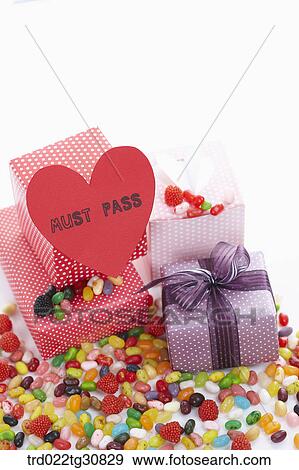 Stock Photo - Boxes and sweets with a MUST PASS message. Fotosearch