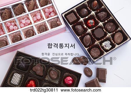Stock Image - Boxes of chocolates and a letter of acceptance. Fotosearch