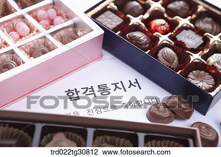 Stock Image - Boxes of chocolates and a letter of acceptance. Fotosearch