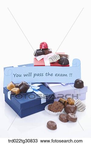 Boxes of cholates and a MUST PASS message View Large Photo Image Stock Image - Boxes of cholates and a MUST PASS message. Fotosearch