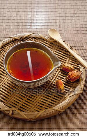 Stock Photography - Cup of gardenia tea and its seeds. Fotosearch