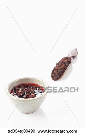 Cup of Omija tea and its fruits View Large Photo Image Stock Image - Cup of Omija tea and its fruits. Fotosearch