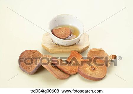 Stock Photo - Cup of quince tea and its fruits sliced. Fotosearch