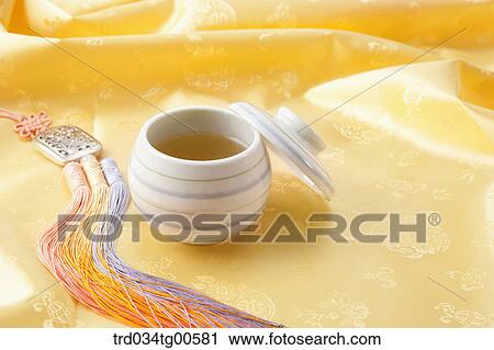 Stock Image - Cup of tea and korean traditional ornament. Fotosearch