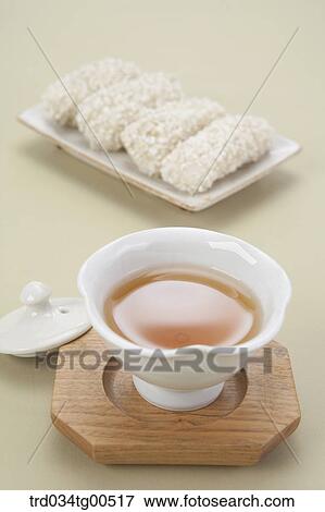 Stock Photo - Cup of tea and korean traditional sweets. Fotosearch